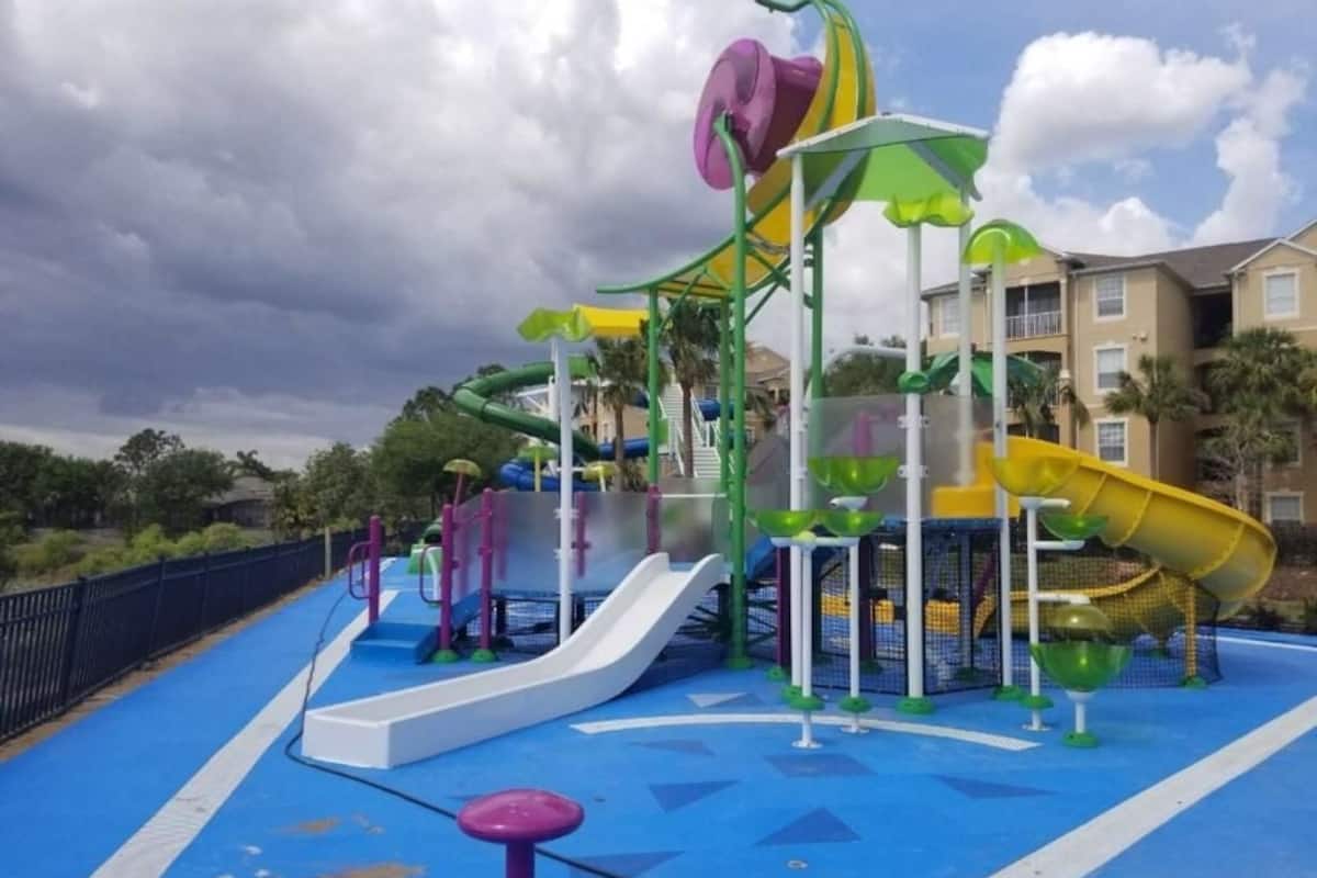 A children's play area with multiple slides and climbing structures.
