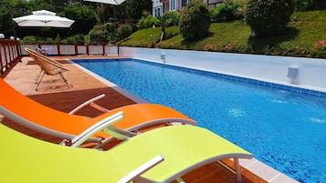 Seasonal outdoor pool, open 1:00 PM to 8:00 PM, pool umbrellas