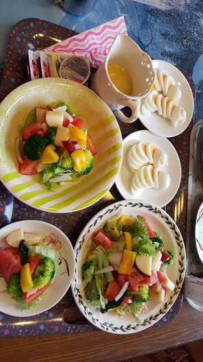 A tray with various dishes including a salad, boiled eggs, and a cup of soup. - Namhae German Village Neuhaus in Korea (Namhae)