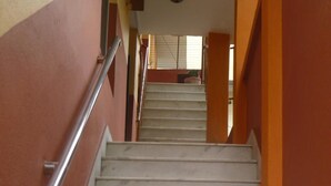 A staircase with marble steps and metal handrails, leading to an upper floor. - Andes House (Kathmandu)