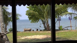 A view of a beach with palm trees and a signboard. - Libong Relax Beach Resort (Ko Libong)