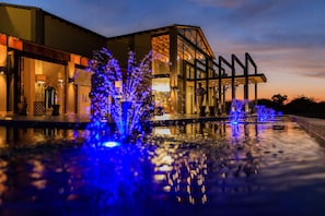 A modern building with a reflective pool and blue lighting. - Palala Boutique Game Lodge & Spa (Lephalale)