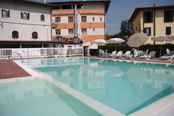 Seasonal outdoor pool, open 9:00 AM to 7:00 PM, pool umbrellas