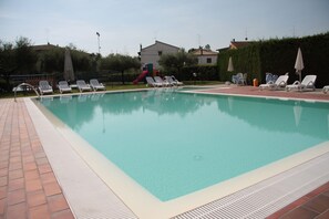 Seasonal outdoor pool, open 9:00 AM to 7:00 PM, pool umbrellas