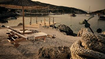 On the beach, sun-loungers, beach umbrellas, beach towels