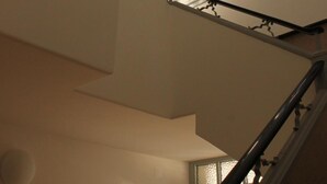 A staircase with a handrail and a window at the top. - Be Coimbra Hostels (Coimbra)