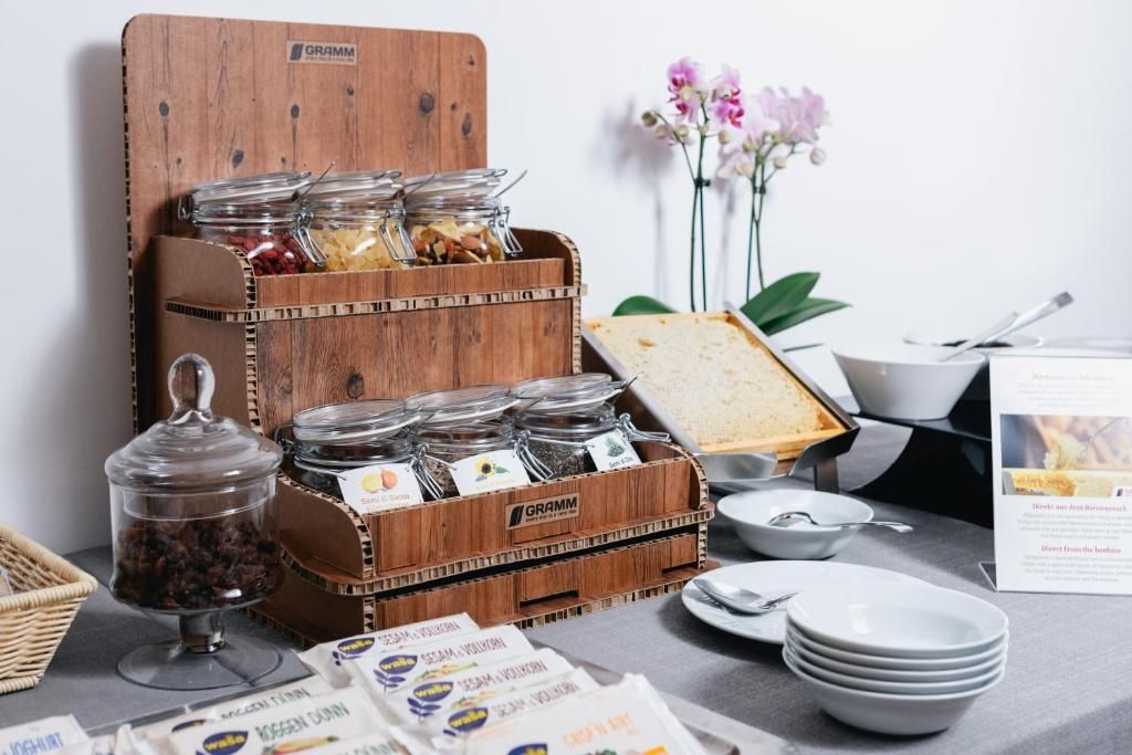 A breakfast buffet setup with various food items and condiments.