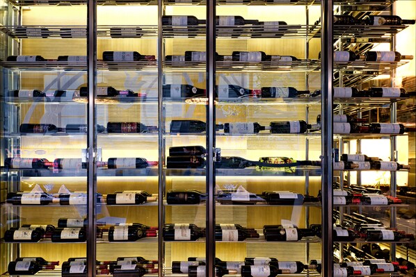 A wine cellar with multiple shelves of wine bottles.