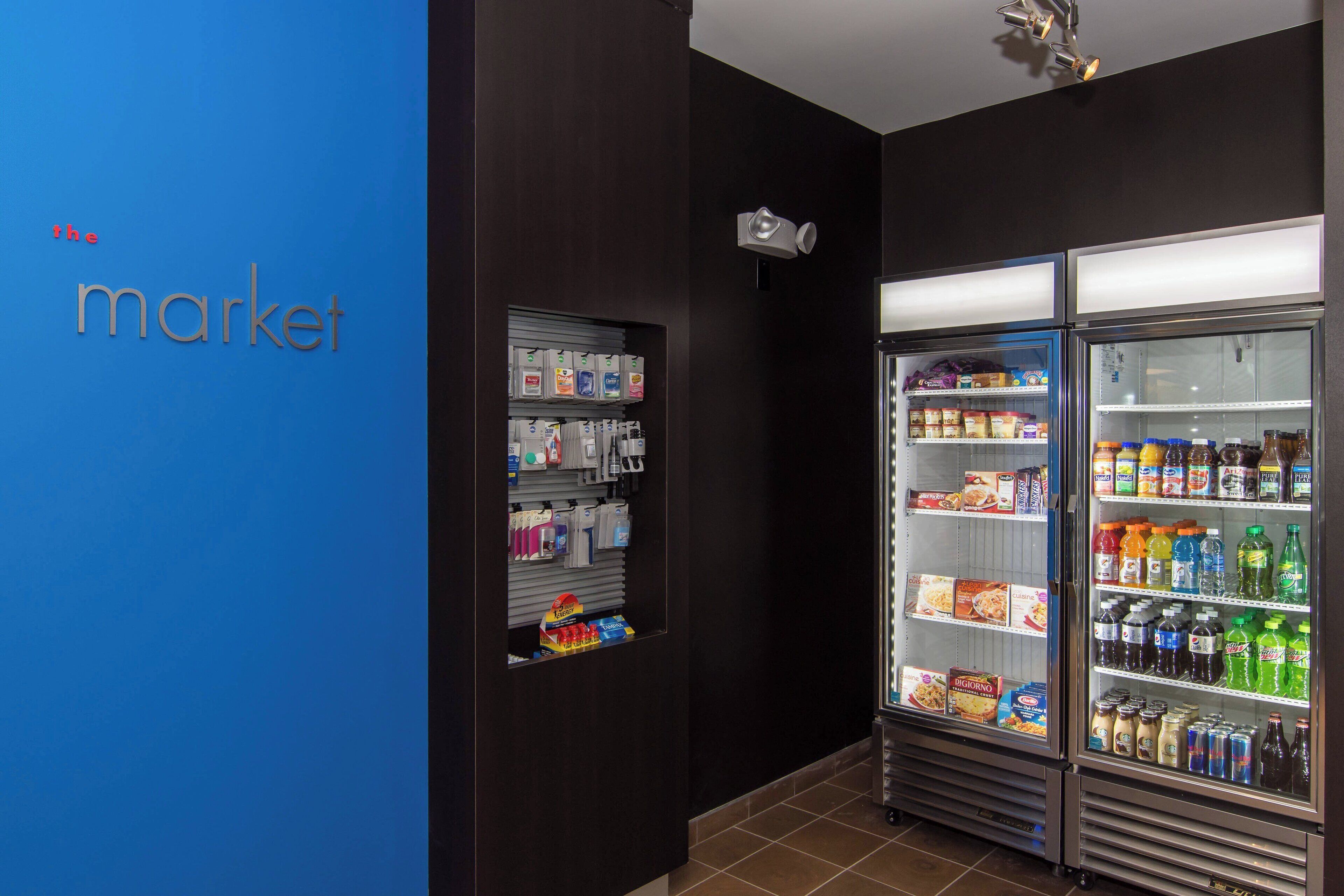 A refrigerated display case in a store with various food items and beverages.