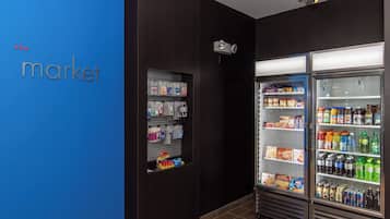 A refrigerated display case in a store with various food items and beverages.