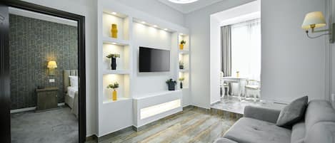 Superior Apartment | Living area | 55-inch Smart TV with satellite channels