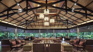 A spacious indoor area with a high ceiling, multiple hanging lights, and comfortable seating arrangements. - Mulu Marriott Resort (Mulu)