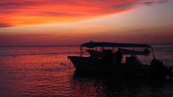 On the beach, white sand, sun-loungers, beach umbrellas
