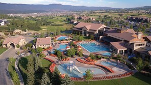 A resort with multiple swimming pools, a children's play area, and a view of the surrounding landscape. - Flying Horse Resort & Club (Colorado Springs)