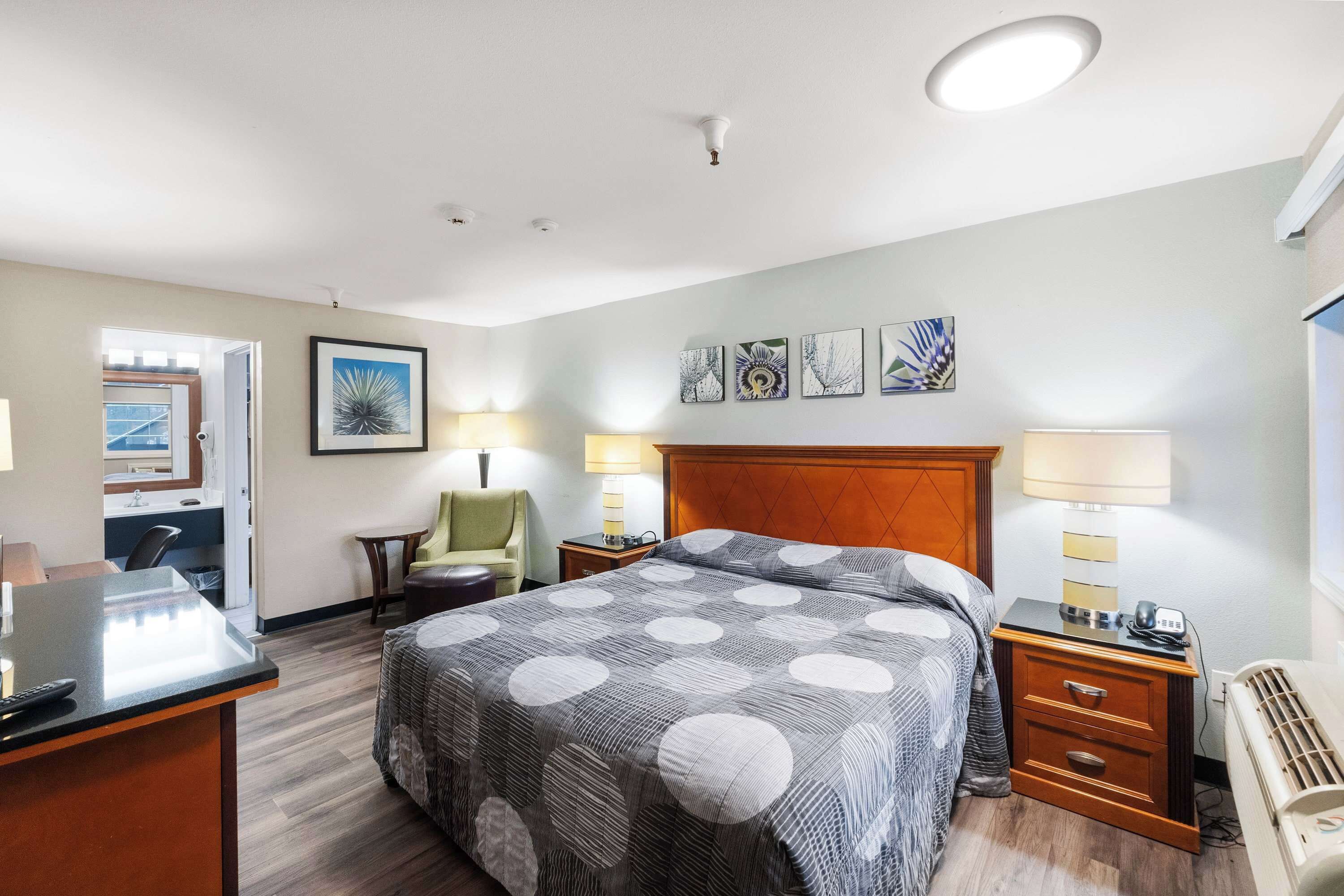 Desk, iron/ironing board, bed sheets