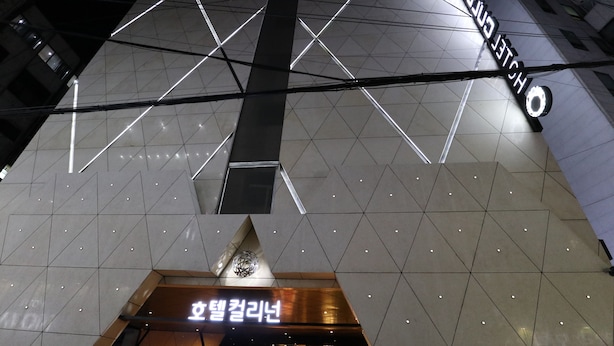 A modern hotel interior with geometric ceiling design and a prominent sign for 'Hotel Euljiro'.