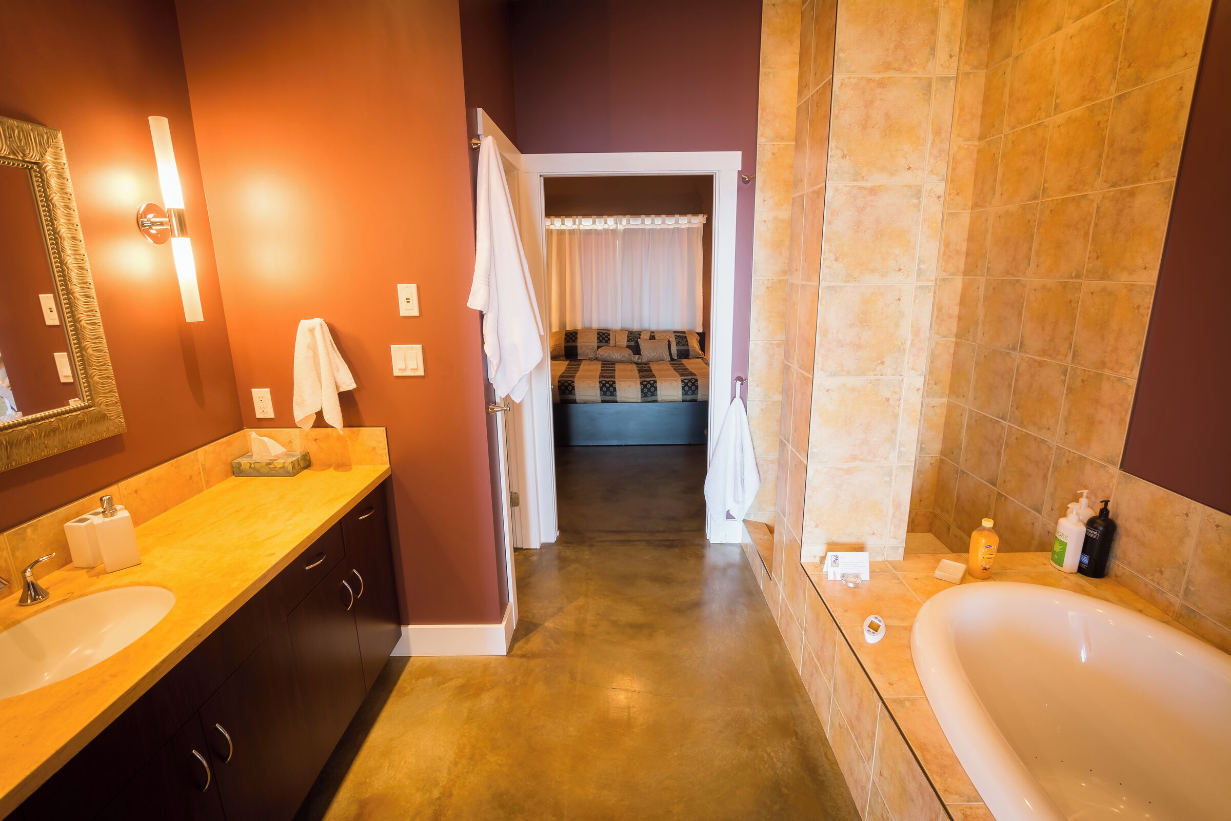 A modern bathroom with a large bathtub, a double sink vanity, and a walk-in shower.