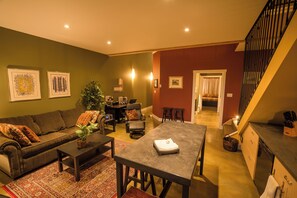 The Pine Suite | Living area | 32-inch flat-screen TV with satellite channels, TV, fireplace - Crooked Tree Guest Suites (Penticton)