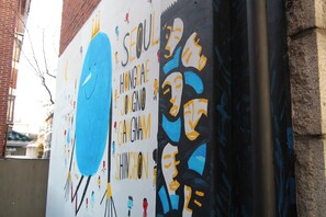 A wall with colorful graffiti art, including text and abstract figures.