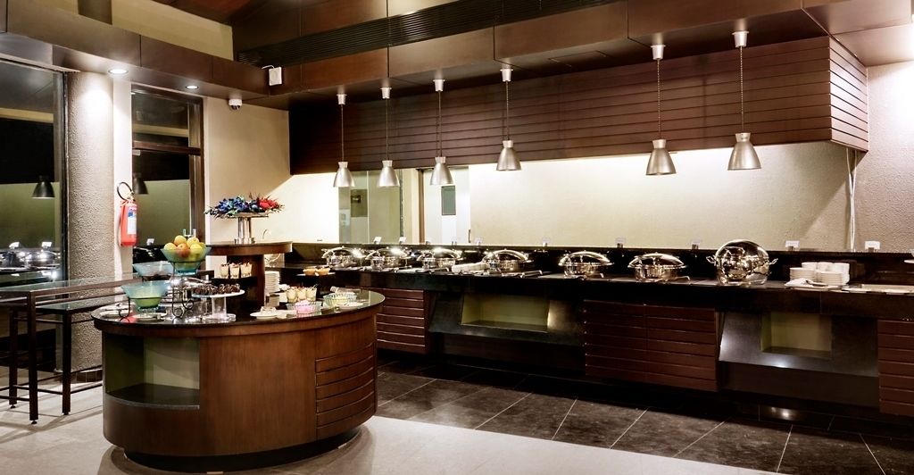 A modern kitchen with a central island, stainless steel appliances, and pendant lighting.