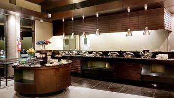A modern kitchen with a central island, stainless steel appliances, and pendant lighting.