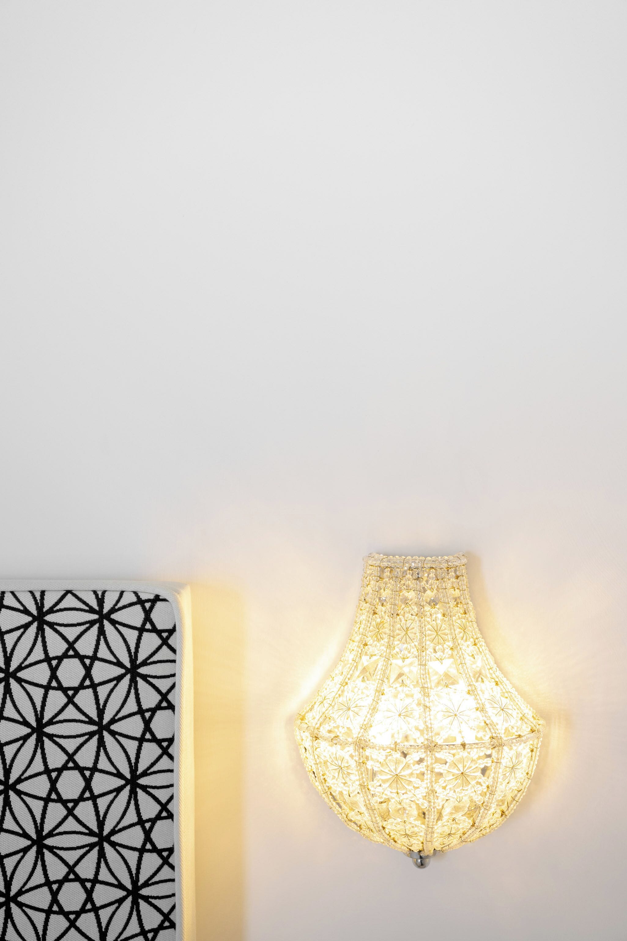 Un luminaire mural doté d’un motif géométrique et d’un design texturé et translucide.