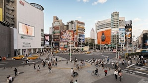 A busy urban intersection with pedestrians, taxis, and commercial buildings. - Nei Jiang Hotel (Taipei)