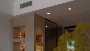 A modern bathroom with recessed lighting, a sink, and shelves displaying decorative items. - Can Arabi Adults Only (Santa Eulalia del Rio)
