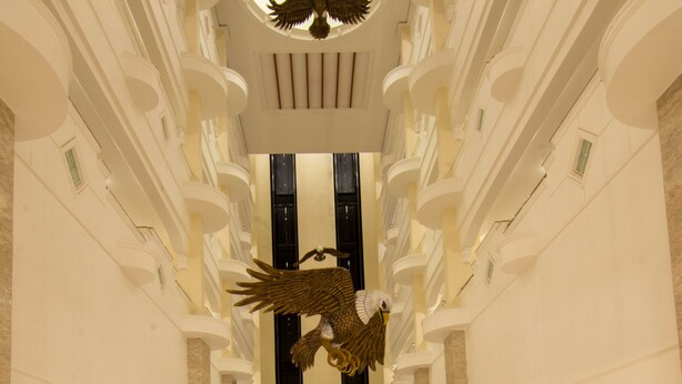A grand lobby with a high ceiling, ornate columns, and a central chandelier. - Shenbaga Hotel and Convention Centre (Puducherry)