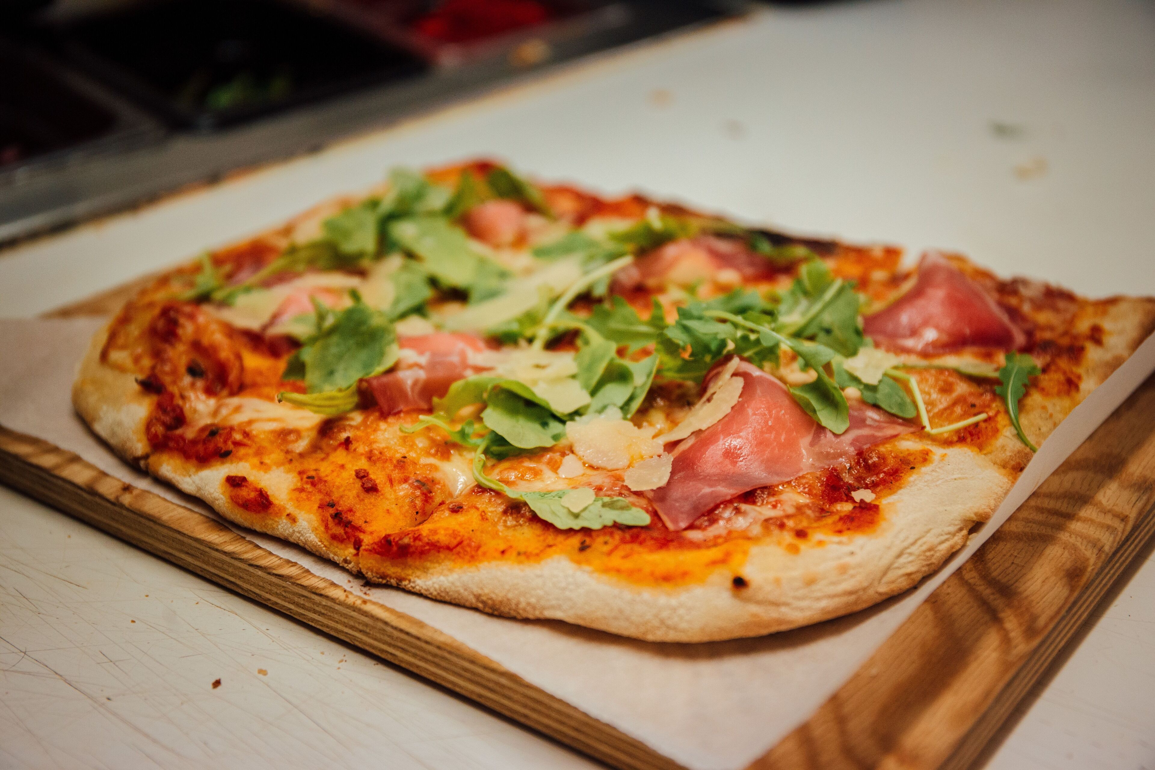 A pizza on a wooden board.