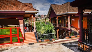 A residential area with houses featuring red-tiled roofs and a gym. - Cari Hotel (Kigali)