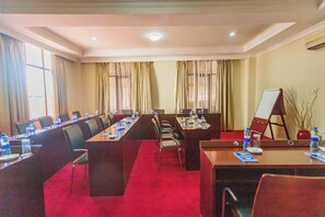 A conference room with a long table, chairs, and a whiteboard. - Millennium Sea Breeze Resort (Bagamoyo)