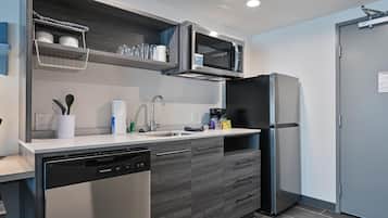 A modern kitchen with a dishwasher, a microwave, and a refrigerator.
