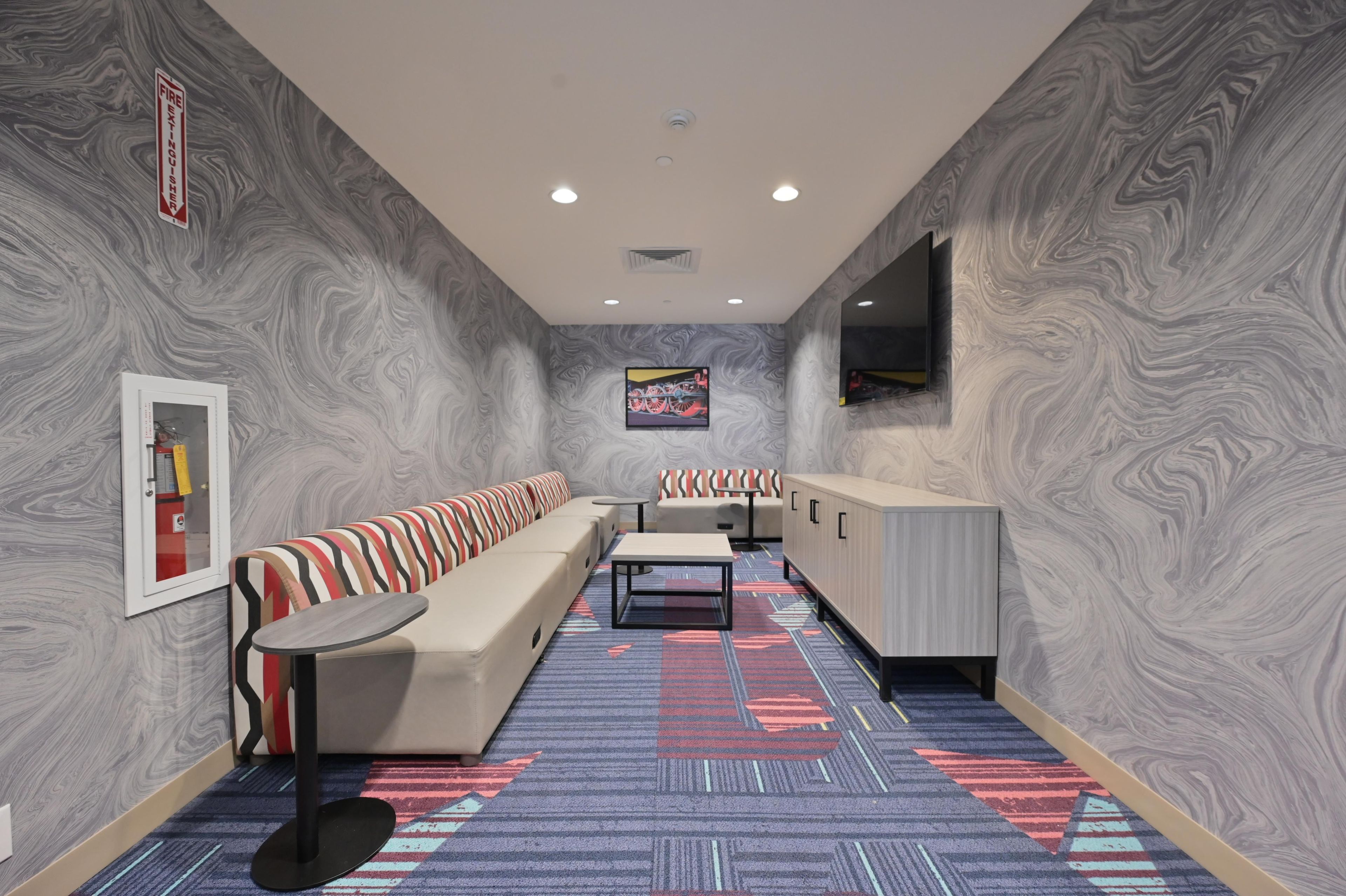 A modern interior with a sofa, a table, and a cabinet.