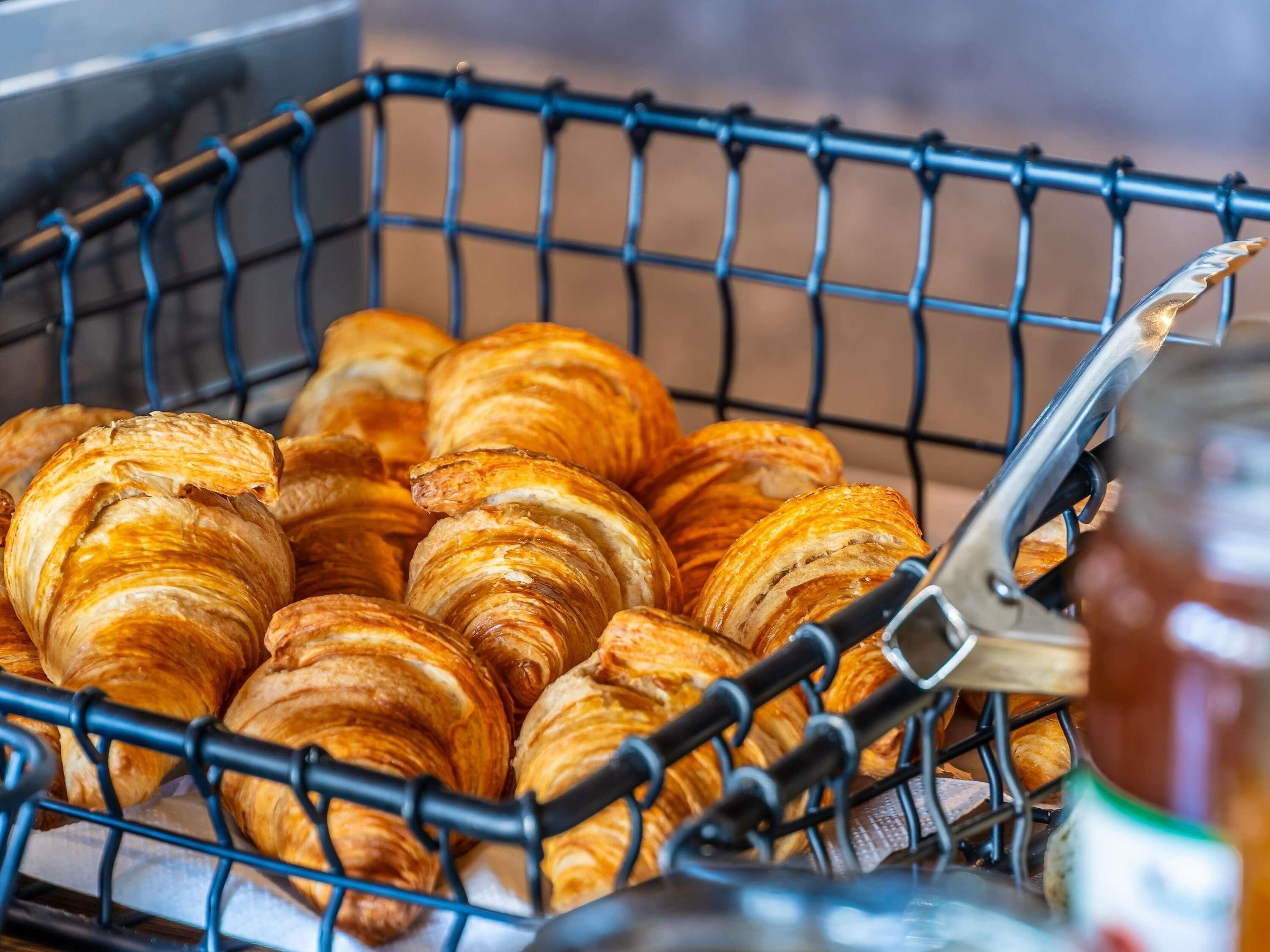 A basket filled with croissants.