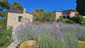A stone building with a window and a metal railing. - Asis de Marratxinet (Marratxi)