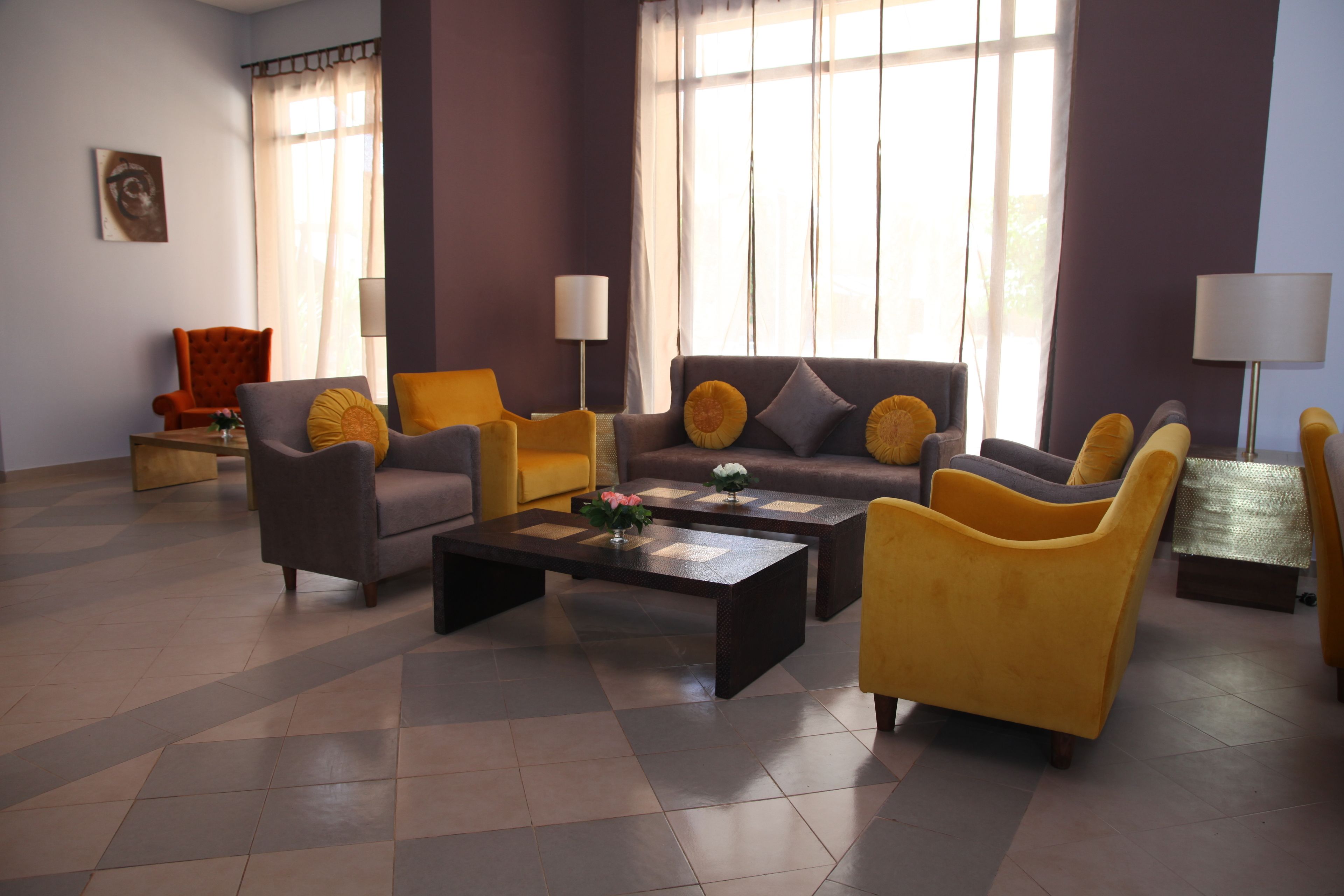 A modern living room with a sofa, armchairs, and a coffee table.