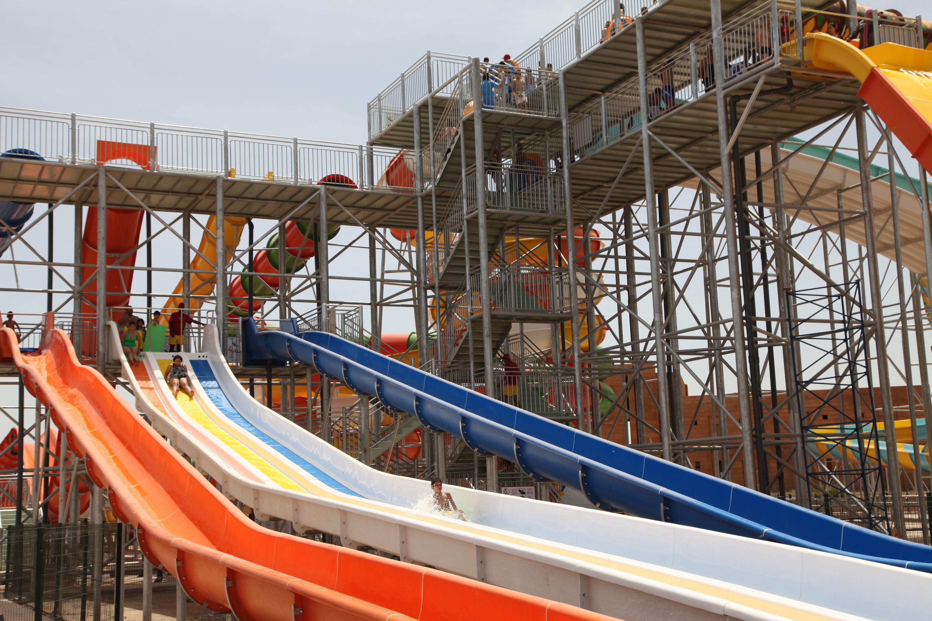 A water park with multiple slides and a metal structure.