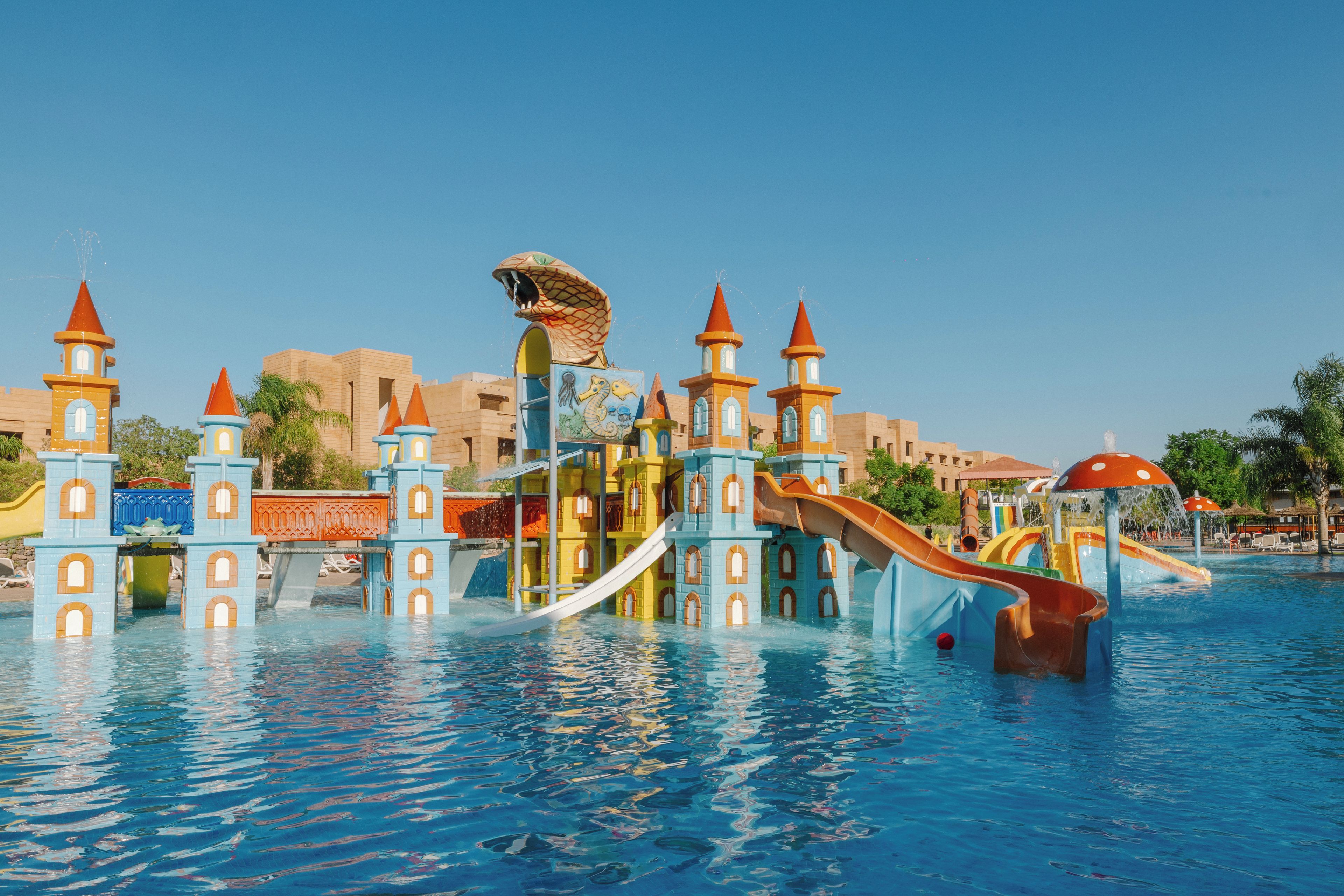 A water park with multiple slides and a castle-like structure.