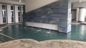 A swimming pool with a stone wall and a 3 ft depth marker. - Oceans One Resort (Myrtle Beach)