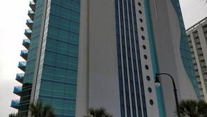A tall hotel with a modern design, featuring a prominent 'Oceans One' sign. - Oceans One Resort (Myrtle Beach)