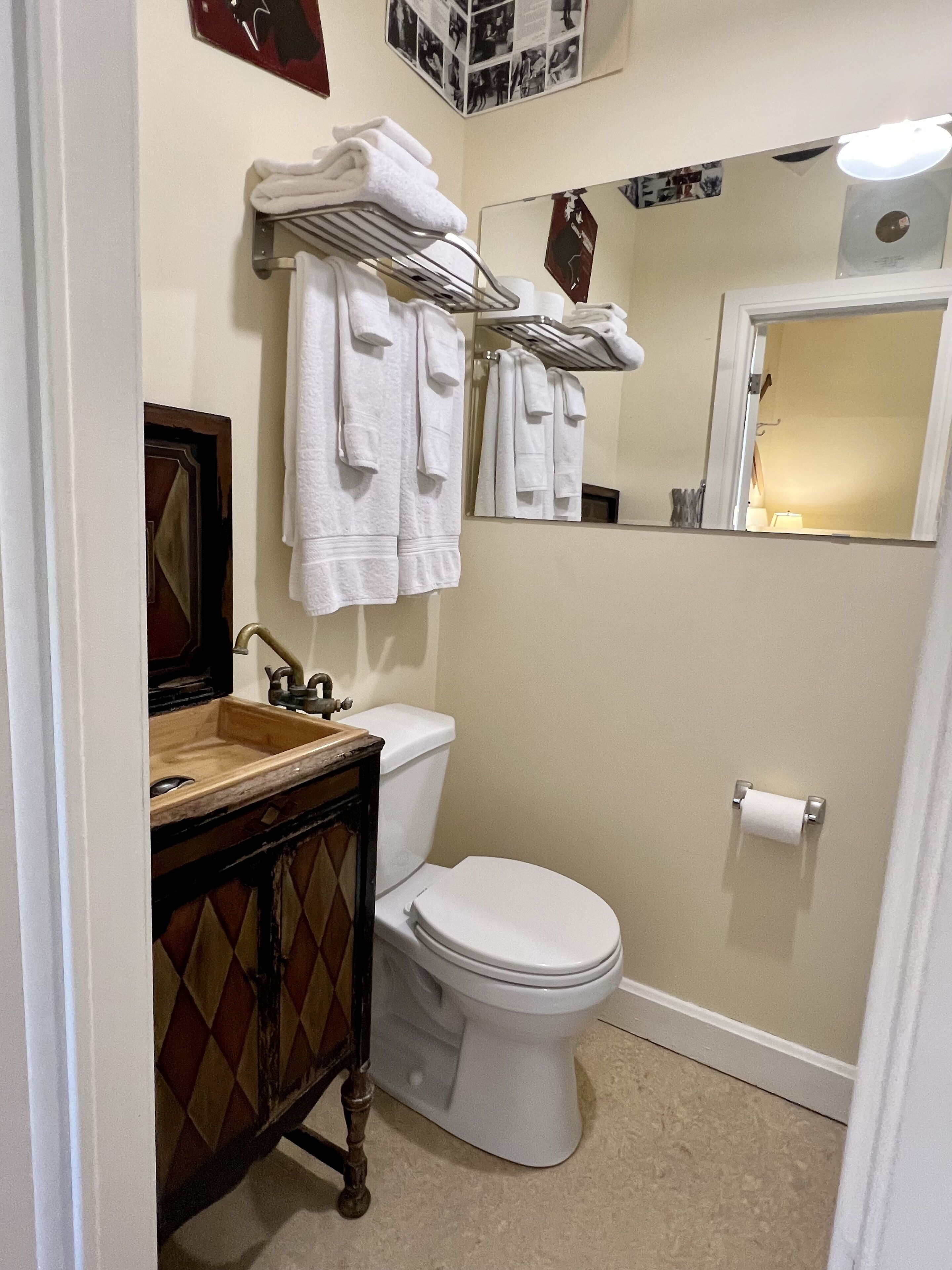 A bathroom with a toilet, sink, and towel rack.