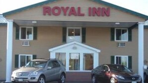 A building with a sign reading "ROYAL INN" and a car parked in front. - Royal Inn Motel (Watertown)