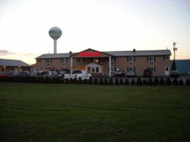 A building with a prominent water tower and a red sign on the roof.