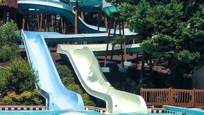 A water park with multiple slides and a pool area. - Anvil Campground (Williamsburg)