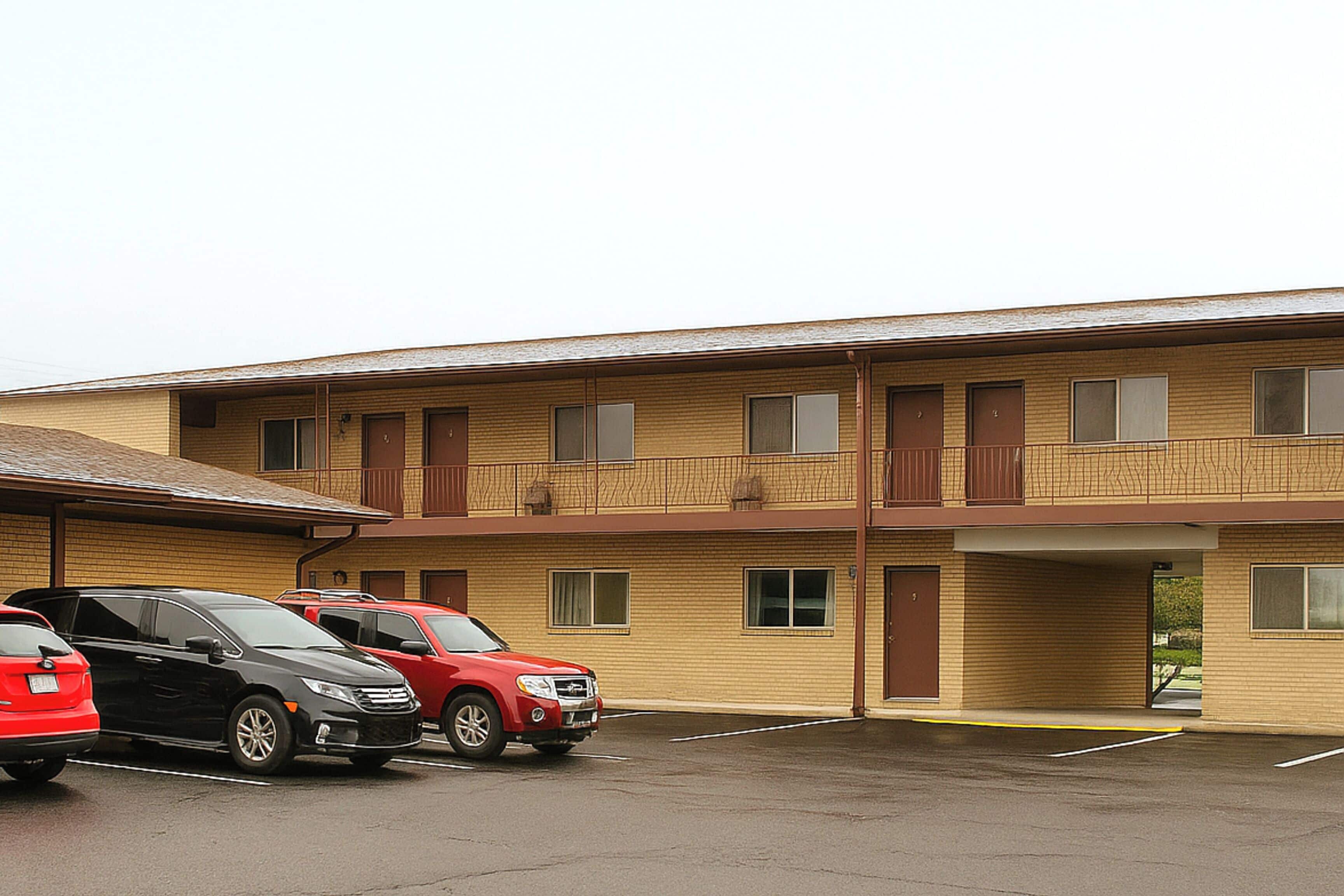 A multi-story motel with a parking lot.