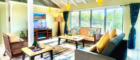 A living room with a sofa, coffee table, and TV.