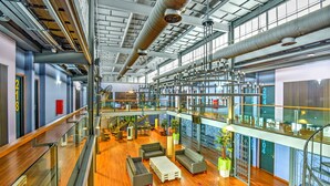 A spacious indoor area with a mezzanine level, wooden flooring, and modern furniture. - Sunday Malacca Near Jonker Street Formerly Quayside (Malacca City)