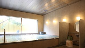A modern bathroom with a large bathtub, a shower area, and a window providing natural light. - Urban Hotel Kyoto Nijo Premium (Kyoto)