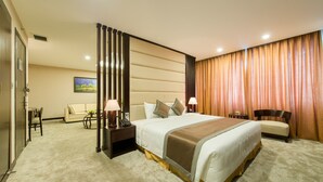 A hotel room with a large bed, bedside tables, a desk, a chair, and a sofa. - Muong Thanh Hanoi Centre Hotel (Hanoi)